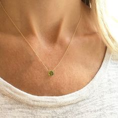 This genuine peridot gemstone sits on a dainty gold filled, sterling silver, rose gold filled or 14k gold chain. Subtle and simple, this beautiful semi-precious stone necklace is perfect by itself or for layering with other necklaces. Peridot is the birthstone for August. The length on the model is 16 inches. Jewelry is handmade by us in our NYC studio. We focus on craftsmanship and quality using only the highest quality materials and handpicked genuine gemstones.  PACKAGING We take pride in cre Gold Peridot Round Pendant Necklace, Gold Necklace With Round Peridot Pendant, Delicate Gold Sterling Silver Birthstone Necklace, Delicate Gold Birthstone Necklace In Sterling Silver, Dainty Peridot Jewelry In Yellow Gold, Dainty Peridot Yellow Gold Jewelry, Delicate Gold May Birthstone Necklace, Minimalist Peridot Birthstone Jewelry, Delicate Gold Necklace With May Birthstone