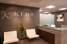 the front desk of kehr law with two white chairs