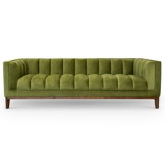 a green velvet couch with wooden legs and an upholstered back, on a white background