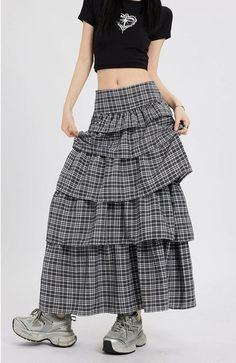 Channel understated chic with this Layered Plaid Maxi Skirt featuring delicate ruffle details.
Crafted from a comfortable blend of mainly cotton, this skirt showcases a multi-layered design that adds a playful twist to the classic plaid pattern. The high-waist cut ensures a flattering silhouette, while the versatile style makes it easy to dress up or down. It's a piece that carries a perfect balance of edgy and professional aesthetics.
Pair this skirt with a tucked-in graphic tee and sneakers fo Tiered Maxi Skirt Outfit, Checked Skirt Outfit, Pattern Maxi Skirt, Plaid Maxi Skirt, Skirt Styling, Long Plaid Skirt, Layered Ruffle Skirt, Ruffle Skirts, Checked Skirt