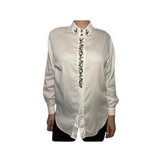 Step into timeless style with our unique vintage blouse  a 100% cotton masterpiece from Turkey! This exquisite piece features a button-up design and trendy shoulder pads. Get ready to turn heads and make a fashion statement like no other! TAG READS:  Steilman, Size 8 (fits like size medium women's)  MEASUREMENTS   (Taken in inches lying flat are approximately) LENGTH:  28 inches  Measure from top to bottom.  CHEST: 18 inches ( 36 around ) Measure from arm pit to arm pit. SLEEVE LENGTH:  28 inche Cotton Blouse With Embroidered Cuffs For Work, Spring Workwear Shirt With Embroidered Cuffs, Elegant Long Sleeve Shirt With Floral Embroidery, Elegant Workwear Shirt With Floral Embroidery, Elegant Floral Embroidered Shirt For Work, White Embroidered Long Sleeve Shirt, Cotton Work Shirt With Embroidered Cuffs, White Collared Embroidered Shirt, White Embroidered Collared Shirt