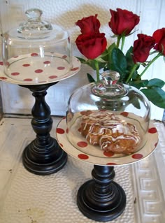 two glass dishes with red roses in them