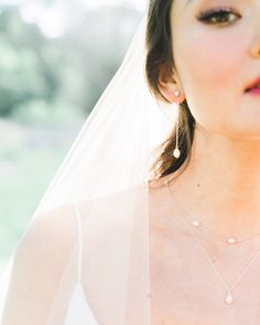 A bride wears Teardrop Pearl Long Earrings, paired with a pearl station necklace. Pearl Long Earrings, Long Pearl Earrings, Long Silver Earrings, Delicate Chain, Pearl Studs, Pearl Drop Earrings, Pearl Drop, Silver Roses, Silver Rose Gold