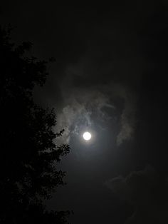 the moon is shining brightly in the dark sky