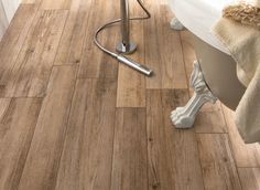 a bathroom with wood flooring and a shower head