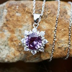 "Handmade Lab Created Nano Color Change Alexandrite - 8mm 2.9 Carat 18\" Sterling Silver Chain Cubic Zirconias Solid Sterling Silver 925 Pendant measures 19mm .79\" long from top of bale The alexandrite in the pendant is just gorgeous! It will change color from purple to fuchsia depending on the light. I've take pictures in different lighting so you can see the color change. There are sparkling cubics set all around the alexandrite so this really sparkles. These can be made up for you in solid white, yellow or rose gold. Just get ahold of me for a free estimate. Custom orders take around 6 - 8 weeks. Care : Store all your sterling silver and vermeil jewelry in plastic baggies to slow down tarnish. Don't let your sterling silver jewelry come in contact with chlorine. It can permanently tarn Cubic Zirconia Gemstones With Halo Setting, Dazzling Cubic Zirconia Gemstones With Halo Setting, Cubic Zirconia Gemstones With Center Stone, Dazzling Brilliant Cut Cubic Zirconia Gemstones, Dazzling Round Cubic Zirconia Gemstones, Silver Gemstones With Brilliant Cut, Silver Round Cut Cubic Zirconia Gemstones, Round Cubic Zirconia Gemstones For Jewelry Making, Purple Cubic Zirconia Jewelry With Brilliant Cut