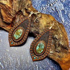 This pair of hand tooled and hand painted leather earrings with beautiful chrysocolla cabochons could become a nice addition to your Boho, hippie, casual, beach, Western clothes. Earrings are made with sterling silver hooks. This piece was MADE TO ORDER, thus in not available. If you would like me to make something for you please contact me for a custom order and we'll discuss the details. I've got plenty of different cabochons in stock, thus I believe we would find something just for you. The p Bohemian Turquoise Leather Earrings, Bohemian Hand-tooled Leather Earrings, Handmade Leather Bohemian Earrings, Handmade Leather Turquoise Earrings, Handmade Turquoise Leather Earrings, Handmade Leather Teardrop Earrings, Handmade Leather Earrings In Turquoise, Bohemian Leather Teardrop Earrings, Bohemian Leather Drop Earrings