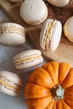 macaroons and pumpkins on a cutting board