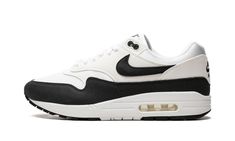 The Women’s Nike Air Max 1 "Black/White" is the women’s sizing of the retro performance running shoe in a simple and versatile colorway.  An easy-to-wear look for the classic Air Max 1, the colorway is outfitted with a white mesh base and light grey felt overlays.  A black felt mudguard matches the black Swooshes on the sides.  Classic “Nike Air’ branding is embroidered on the heel and “Nike” and Swoosh insignia are found on the tongue.  Underfoot, a visible Air unit in the heel of the white foa Air Max 1 Black, White Black Shoes, Race Running, Nike Air Max 1, Stadium Goods, Cotton Bottoms, Black Felt, Loafer Sneakers, Vintage Pants