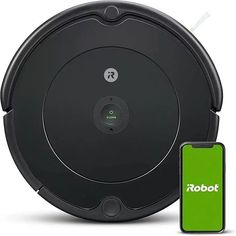 an image of a robot vacuum cleaning the floor with its appliance next to it