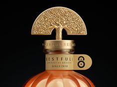 a bottle of perfume with a tree on top