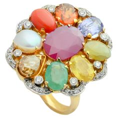 A simple 18K gold ring in the form of oval shape set with the nine planetary gems (navratna) and full cut diamonds. Starting with blue sapphire at the lower end, the nine gemstones include a coral, yellow sapphire, emerald, cat's eye, cultured pearl, hessonite garnet, blue sapphire and a natural ruby at centre. The concept of navratna is born at the core of Indian hindu culture, to attain the maximum prophylactic powers of the nine gems, the gems need to be set with open-back mounts so that light passed through the stones transmitting their energies to the body. The ring embodies nearly 11.50gms of fine gold and 14.21cts of natural stones accompanied with 0.60cts diamonds. Navratna Ring, Whiskey Flask, Hindu Culture, Multi Sapphire, Hessonite Garnet, Cute Nike Shoes, Zambian Emerald, 18k Gold Ring, Uncut Diamond