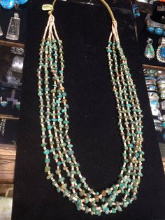 "- PLEASE contact me before purchase if you are interested in this item. The gallery has a few to choose from that are very similar. - Santo Domingo Pueblo artist Daniel Calabasa, Native American Indian made, vintage, mostly green American turquoise & shell heishi 5 multi-strand necklace... in an old classic style. With very small heishi shell beads. Turquoise beads in irregular shapes & sizes, yet all quite similar... Unusual interesting finish is woven nylon. Hangs 16\" 137R - This stu Cheap Turquoise Beaded Necklaces For Festivals, Southwestern Turquoise Heishi Beads Jewelry, Southwestern Green Turquoise Necklace, Hand-strung Green Beaded Necklaces Southwestern Style, Southwestern Style Green Single Strand Jewelry, Old Classic Style, Pueblo Native Americans, Heishi Necklace, Turquoise Jewelry Native American