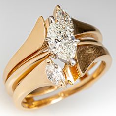 This pretty two ring wedding set consists of a diamond solitaire style engagement and a diamond guard style ring. The engagement ring contains one (1) marquise brilliant cut diamond set into a six-prong head. The guard ring is accented with two (2), prong set, marquise brilliant cut diamonds. The set measures 13.1mm at the top, rises 5.9mm above the finger, tapering to 4.9mm wide and 1.2mm thick at the base of the shanks. This ring is currently a size 4. Classic Marquise Cut Wedding Ring With Tension Setting, Marquise Tension Setting Formal Jewelry, Marquise Tension Setting Fine Jewelry, Diamond White Marquise Cut Diamond Marriage Ring, Anniversary Solitaire Diamond Ring Marquise Cut, Marquise Diamond Ring For Marriage, Anniversary Marquise Cut Solitaire Diamond Ring, Formal Marquise Tension Setting Wedding Jewelry, Marquise Cut Diamond White Diamond Ring For Marriage