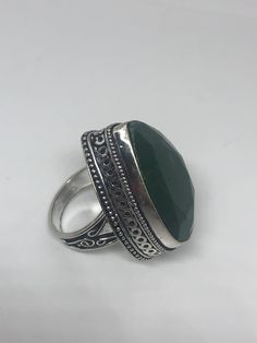 Vintage raw green emerald ring Lovely polished white bronze silver has the look of 925 set with a huge Green emerald Does not tarnish set in very detailed vintage filigree Size 7 We can size these with an additional $10-$20 fee for the jeweler All rings are shipped free in the US in a nice gift box. Check out our over a THOUSAND great reviews Engraving is $4 per letter and is not always perfect depending on the piece. It can take a few days if the jeweler is busy. This is payable to Paypal Judit Bohemian Green Emerald Gemstone Ring, Bohemian Green Emerald Ring, Green Bohemian Emerald Ring, Handmade Green Emerald Cut Ring, Handmade Green Emerald-cut Emerald Ring, Handmade Silver Emerald Ring For May Birthstone, Bohemian Green Emerald Ring As A Gift, Bohemian Green Emerald Ring Gift, Unique Green Emerald Ring With Stone Setting