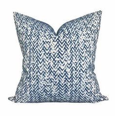 a blue and white pillow on a white background