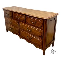 a large wooden dresser sitting on top of a white floor