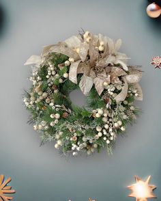 a christmas wreath is hanging on the wall next to other holiday decorations and stars around it