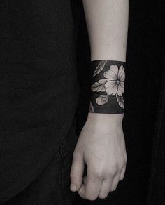 a person with a flower tattoo on their arm