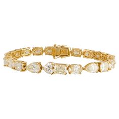 The Following Item we are offering is this Beautiful Rare Important 18KT Yellow Gold Large Glittering Fancy Cut Yellow Diamond Tennis Bracelet. Bracelet is comprised of over 23CTS Magnificent Rare Gorgeous Fancy Oval, Heart, Pear, & Emerald Cut Glittering Diamonds!!! The Diamonds are of Beautiful Fine Quality. This Magnificent Bracelet is a Rare Sample Piece From a Private Manufacturer that sold to select Five Star Hotel and Fine Jewelry Stores. Original Retail $250,000 and Comes with a Certificate from the IGI. Bracelet Tennis, Modern Bracelets, Fancy Yellow Diamond, Diamond Tennis Bracelet, Five Star Hotel, Star Hotel, Fancy Diamonds, Tennis Bracelet Diamond, Diamond Drops