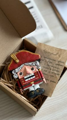 a wooden toy soldier in a box on a table