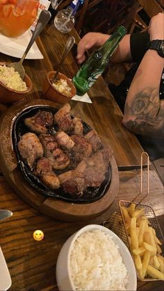 a man sitting at a table with food on it