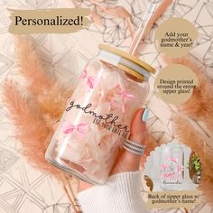 a person holding a jar with pink flowers on it and the words, personalized