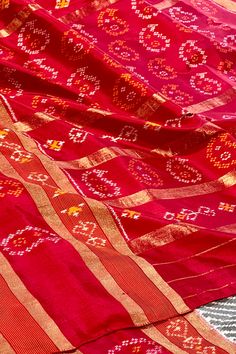 This exquisite pochampally ikkat silk saree is grey color is handwoven. The body is adorned with leheriya pattern while the elaborate broad border on one side is in maroon color with woven paisley motifs while the other side is plain along with gold zari lines. The maroon colored pallu repeats the paisley motifs along with gold zari lines. The blouse is in maroon color with lehriya pattern and decorated border in traditional ikkat designs. Approximate Length 6.5 mtrs (inclusive of blouse length) Red Tussar Silk Saree With Motifs, Red Saree With Woven Motifs, Ceremonial Red Motifs Saree, Red Tussar Silk Pre-draped Saree With Motifs, Red Ikat Print Saree For Puja, Silk Cotton Sarees, Maroon Color, Ikkat Silk Sarees, Blouse Length