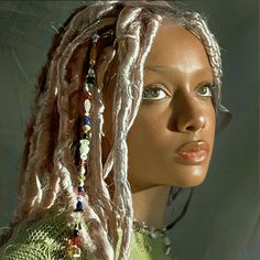 a woman with dreadlocks on her head