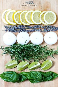 lemons, herbs and candles on a cutting board