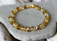 "8mm Citrine Bracelet, Woman Citrine Jewelry, Chakra Balancing Energy Bracelet, Gold Crystal Bracelet, Yellow Bead Bracelet, Gift for Her, Woman Birthstone Bracelet, Girlfriend Birthday Gift, November Gemstone Jewelry, Solar Plexus Chakra Bracelet Gorgeous bangle bracelet made of 8 mm. Citrine beads and gold crystals. The beads are strung on hard memory wire. With gold plated magnetic  clasp. Ready to ship. Choose your wrist size with the option. 5.5\" - 14 cm. 6\" - 15.2 cm. 6.5\" - 16.5 cm. 7\ Spiritual Faceted Crystal Bangle Bracelet, Gold Citrine Round Beaded Bracelets, Gold Citrine Beaded Bracelets With Round Beads, Gold Citrine Beaded Bracelet With Gemstone Beads, Gold Citrine Gemstone Beaded Bracelets, Gold Citrine Round Beads Crystal Bracelet, Gold Crystal Bracelet With Gemstone Beads For Healing, Gold Crystal Rondelle Bracelet With Faceted Beads, Gold Faceted Crystal Bracelet