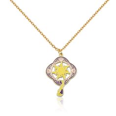 a yellow and pink necklace with an ornate design on the front, hanging from a gold chain