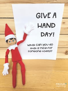 an elf holding a sign that says give a hand day what can you do that is nice for someone today?