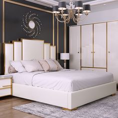 a white bed sitting in a bedroom on top of a hard wood floor next to a chandelier