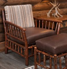 a chair and ottoman in front of a wooden wall