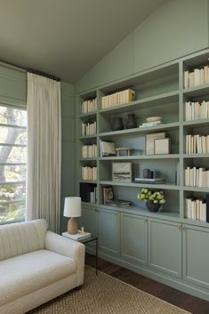 a living room filled with furniture and bookshelves