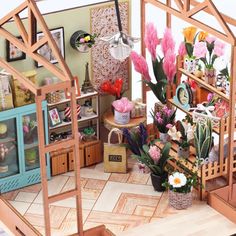 a doll house with flowers and furniture inside