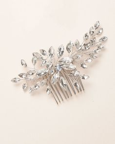 FELICIA CRYSTAL BRIDAL COMB (TC-2452)Turn every head as you walk down the aisle in our Felicia Crystal Bridal Comb. With a bold, floral inspired design, Felicia features hand wired crystals that sparkle endlessly. Lightweight & easy to style.DETAILS• Crafted with crystal gemstones.• Measures 1.5 x 4 inches.• Metal comb is wired to the back of the design.• Finish: silver.• Versatile & flexible, this piece can be worn in nearly any hairstyle. The hand wired branches can be shaped for the p Silver Wedding Hair, Lace Cathedral Veil, Crystal Comb, Wedding Comb, Pink Pouch, Metal Comb, Pearl Earrings Wedding, Wedding Hair Comb, Bridal Comb