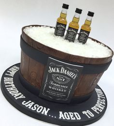 three bottles of jack daniels whiskey in a barrel cake