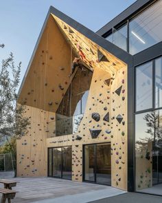 an outdoor climbing wall in front of a building