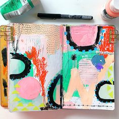 an art journal with paint and markers on it