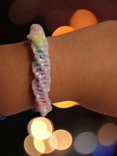 a close up of a person's arm wearing a bracelet with beads on it