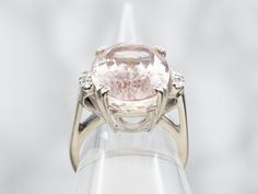 Be the belle of the ball in this breathtakingly beautiful white-gold, oval-cut kunzite ring with diamond accents – the perfect accessory for adding a touch of sparkle and shine to any look! Party hard without worrying – you're worth it!Metal: 14K White GoldGem: Kunzite 11.43 CaratsGem Measurements: 16.1 x 12.1 mm, OvalAccents: 4 Diamonds totaling .12 Carats, SI in Clarity, G-H in ColorRing Size: 5.25Marks: "14K >M-G->" Stamped on the inside band Oval Kunzite Ring For Anniversary, Luxury Kunzite Ring For Formal Occasions, Luxury Kunzite Engagement Ring, Fine Jewelry Oval Kunzite Rings, Kunzite Ring Fine Jewelry Gift, Luxury Oval Kunzite Jewelry, You're Worth It, Kunzite Ring, Pocket Watch Chain