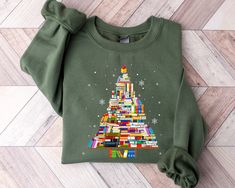 "Book Tree Christmas Sweater, Christmas Tree Made of Books Sweatshirt, Gift for Book Lover, Gift For Teachers, Bookworm Christmas Hoodie ORDER INSTRUCTIONS ➤ Check and review all listing photos. ➤ Pick up your item's size and color from drop down menus. ➤ Choose the quantity. ➤ Click \"Add to Cart\" button. ➤ Fill in the personalization box as recommended if provided. ➤ You can go back to add more item or you can complete the checkout process. ➤ Click \"Proceed to Check Out\". WHICH SIZE FITS ME Christmas Tree Made Of Books, Teacher Christmas Tree, Christmas Tree Book, Tutoring Business, Books Shirt, Ugly Sweater Christmas, Book Tree, Book Christmas, Christmas Gifting