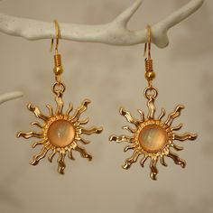 Make a statement with these pretty light pink sun drop earrings for women. These cool quirky gold plated and acrylic sun earrings are a great way to add a nice touch to your outfit. The charm on these sun dangle earrings measures at 3cm x 2.7cm and is attached to a gold plated hook. Please feel free to get in touch with us at Funky Earrings UK if you have any questions. We also have a wide range of other cute and unusual earrings in our shop.