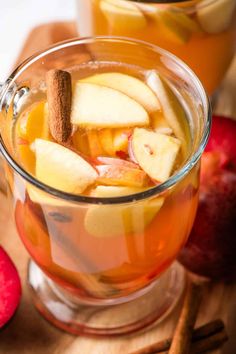 an apple cider with cinnamon and apples in the background