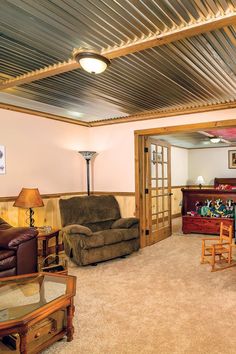 a living room filled with furniture and a metal ceiling