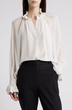 Cut from frothy chiffon and refined with shirred details, this graceful top will be worn from work days to evenings out. 26 1/2" length High neck Long sleeves 100% polyester Dry clean Imported Feminine Workwear Blouse With Smocked Cuffs, Elegant Blouse With Smocked Cuffs For Daywear, Chic Ruffled Silk Chiffon Blouse, Luxury Ruffled Blouse For Work, Luxury Ruffles Blouse For Work, Elegant Billowy Blouse With Gathered Sleeves, Elegant Chiffon Blouse, Formal Chiffon Blouse With Ruffles, Elegant Ruched Blouse For Evening