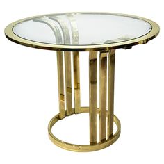 a round glass table with gold metal frame