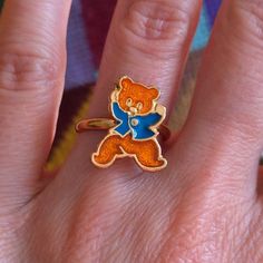 Adorable Novelty Vintage 70s 80s Bear Ring in Orange Gold & Blue This listing is for one ring only. The other rings in last photo are also available in the shop separately.  Please note that colors can vary from screen to screen, and in real life. Adjustable! It's around a size 5, but you can change that to fit your finger best. Best for smaller finger in general. Metal is gold toned. Condition: 2 Condition Scale:  1-Immaculate Vintage Condition (Rare) 2-Unnoticeable Vintage Wear or Spots that a Retro Style Gold Rings For Gifts, Retro Gold Rings For Gifts, Retro Gold Rings As Gifts, Retro Gold Rings For Gift, Vintage Ring For Birthday, Handmade Retro Rings As Gift, Vintage Blue Enamel Rings, Retro Collectible Enamel Jewelry, Handmade Enamel Vintage Rings